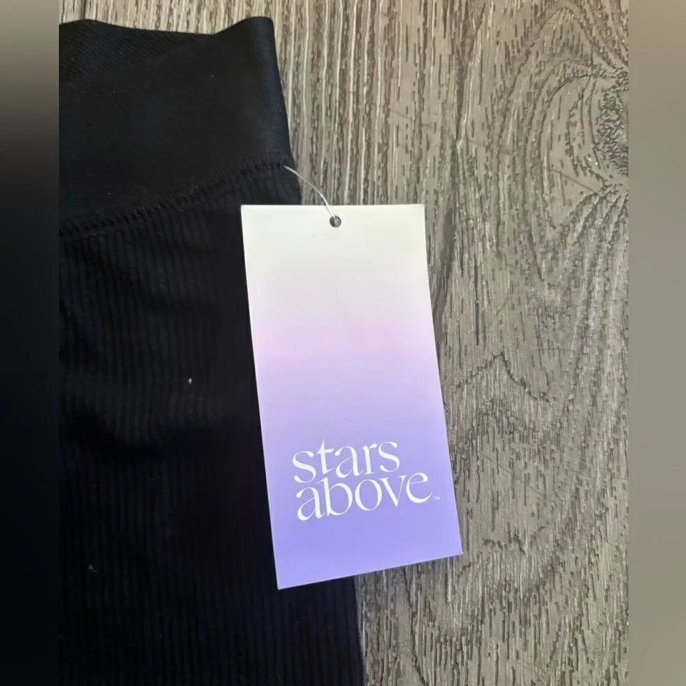 Stars above woman’s ribbed  knit pajama pants